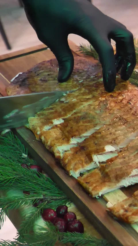 Close-up of hand cutting grilled salmon steak with vegetables. Christmas table Stock Footage 304437852