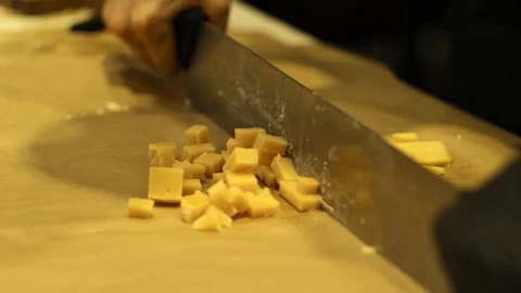 Close-up of hand cutting large pieces of French cheese.Cutting Cheese Slices Stock Footage 280108533