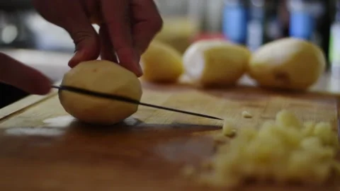 Close up of hand cutting a potato in the kitchen Stock Footage 239197887
