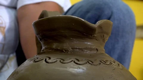 Close Up of Hand Decorating Clay Pot with Traditional Pattern in Pottery Stock Footage 337923052