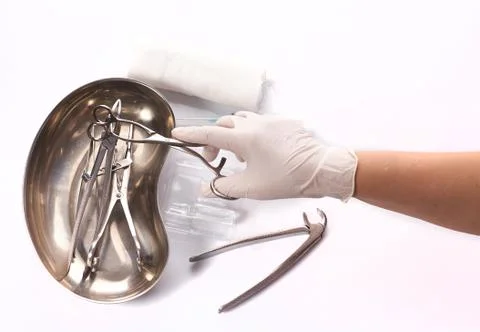 Close up hand dentist is selecting a tool used to treat patient teeth. Stock-Fotos