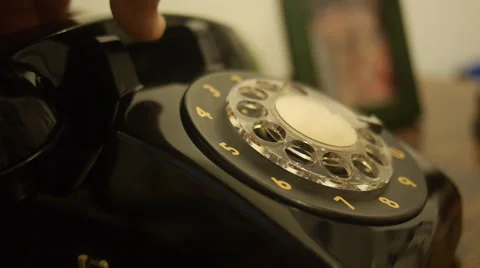 Close-up hand dialing a number in old telephone Stock Footage 56143175