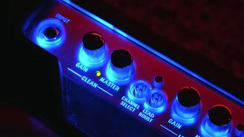 Close up of Hand doing Changing in Amplifier setting Stock Footage 123858750