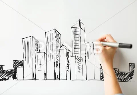 Close up of hand drawing city on white board Stock Photos
