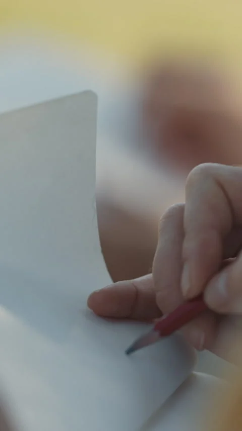 Close-up of a hand drawing with a pencil on paper Stock Footage 328643892
