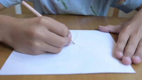 Close-up of hand drawing with a pencil on white paper. Concept of sketching Stock Footage 316090960