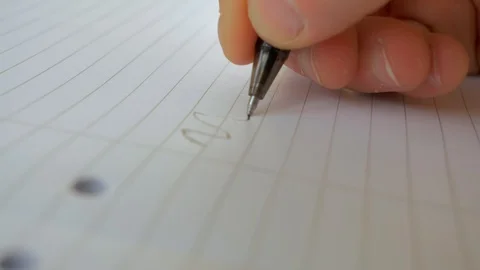 Close Up of Hand Drawing Waved Line Across Piece of Lined Paper Stock Footage 127986403