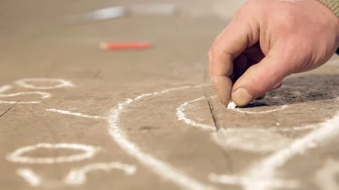 Close-up hand that draws a chalk sketch on the table Stock Footage 77025381