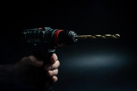Close up hand drill concept. black background. craftsmanship Stock Photos