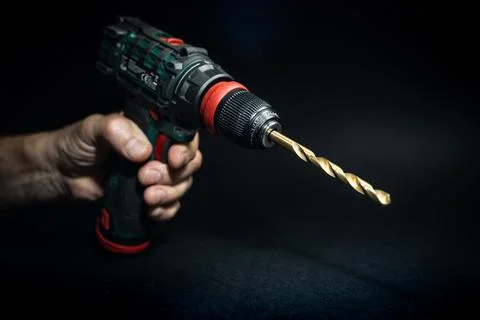 Close up hand drill concept. black background. craftsmanship Stock Photos