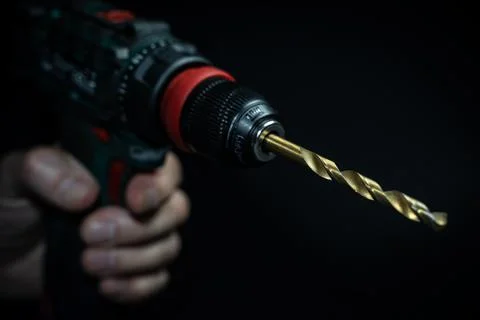Close up hand drill concept. black background. craftsmanship Stock Photos