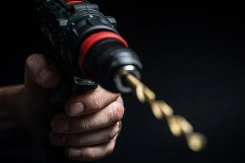 Close up hand drill concept. black background. craftsmanship Stock Photos