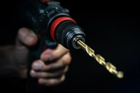 Close up hand drill concept. black background. craftsmanship Stock Photos