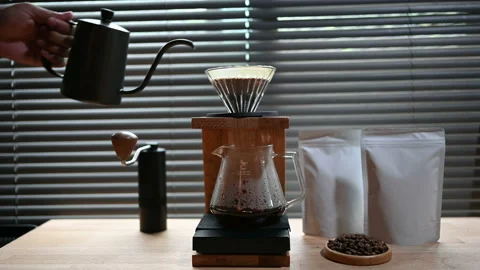 Close up hand drip coffee by spilling hot water through a layer of ground on the Stock Footage 156037514