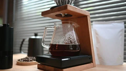 Close up hand drip coffee by spilling hot water through a layer of ground on the Stock Footage 158039428