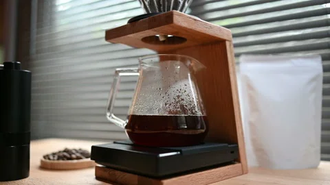 Close up hand drip coffee by spilling hot water through a layer of ground on the Stock Footage 158039502