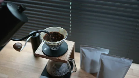 Close up hand drip coffee by spilling hot water through a layer of ground on the Stock Footage 162669540