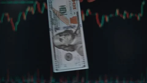 Close-up of a hand dropping a hundred-dollar bill against the background of a Stock-Footage 338301434