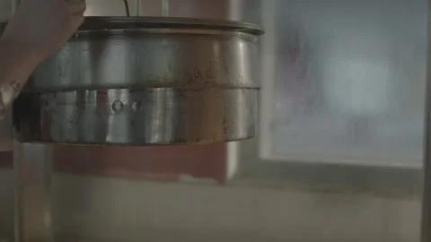 Close Up Hand Dumping Popcorn Machine At Movie Theater Stock Footage 134743812