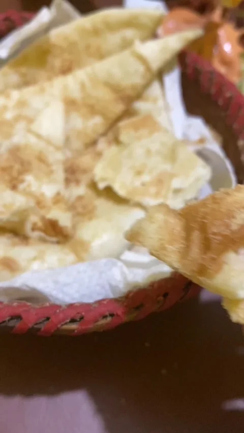Close up of hand eating delicious flatbread naan with spicy curry sauce Stock Footage 340140961