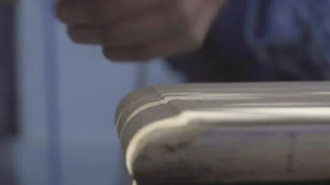 Close up of the hand of an elderly craftsman sanding and cleaning sawdust Stock Footage 140293041