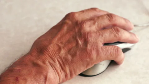 Close-up hand of an elderly man clicking a mouse, elderly people and digital dev Stock Footage 138617012