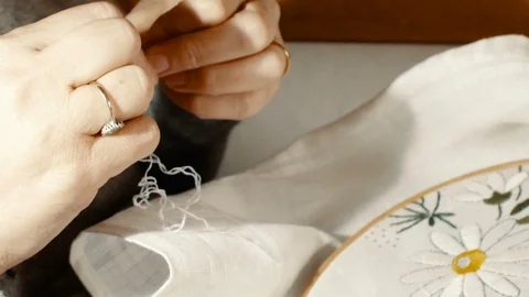 Close up hand that embroiders a flower with the use of a wooden frame for embroi Stock Footage 87709608