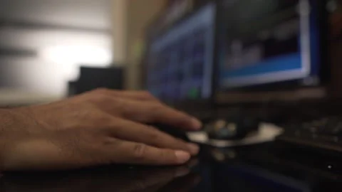 Close-up hand of an engineer is holding the computer mouse in the control room Stock Footage 133487019