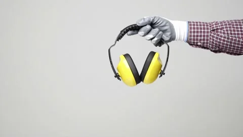 Close up hand of engineer holding earmuff on isolated white background. Engineer Stock Footage 144258913