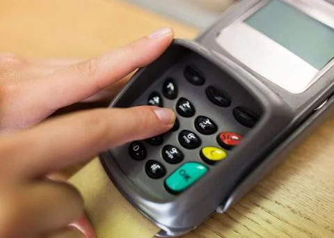Close up of hand entering code to money terminal Stock Photos