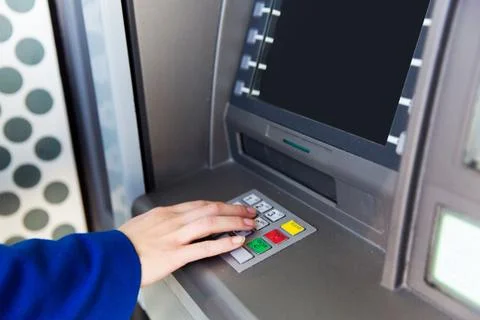 Close up of hand entering pin code at cash machine Stock Photos