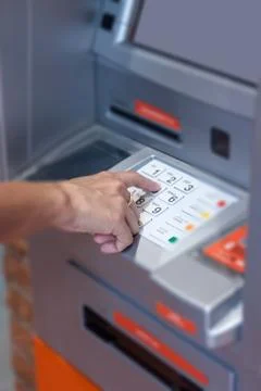 Close up of hand entering pin code at Automated Teller Machine Stock Photos