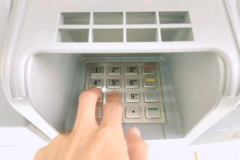Close-up of a hand entering a PIN code on an ATM machine Stock Photos