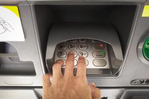 Close-up of a hand entering a PIN code on an ATM Stock Photos