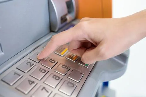 Close-up of hand entering PIN/pass code on ATM/bank machine keypad 스톡 사진