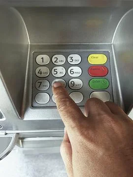 Close-up of hand entering PIN/pass code on ATM/bank machine keypad Fotos de archivo