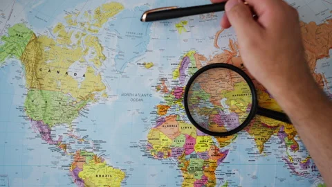 Close-up of hand examining Greenland on physical map, symbolizing growing g.. Stock Footage 346471158