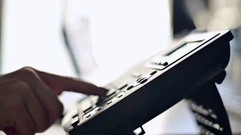 Close-up of the hand of a female office worker dialing a number on a landline Stock Footage 149252463