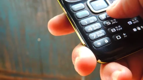 Close up hand finger tip pressing mobile cell phone telephone keypad on palm Stock Footage 141382964