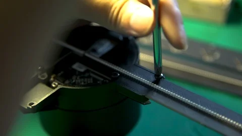Close up of hand fixing a screw with a screwdriver beside on a fan Stock Footage 96225552