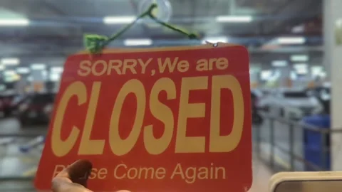 Close up of Hand Flipping Sign from Closed to Open on Glass Door of a Shop Stock Footage 328973104