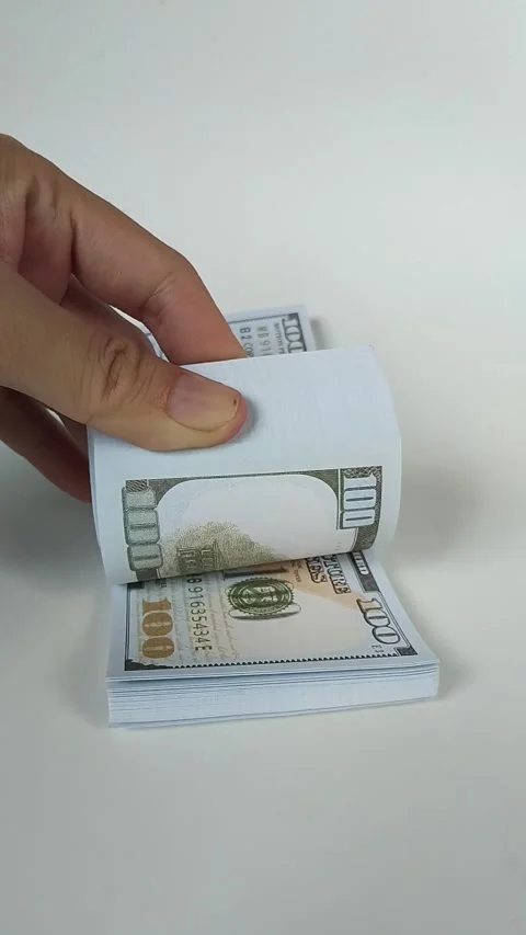 Close-up of a hand flipping through a stack of U.S. one hundred dollar bills Stock Footage 324848262