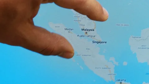 Close up hand gesture on touch screen zoom in Kuala Lumpur city Malaysia Video stock 128456736