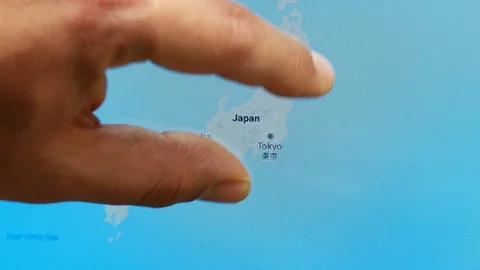 Close up hand gesture on touch screen zoom in Tokyo city Japan Stock Footage 128460110
