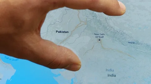 Close up hand gesture on touch screen zoom in New Dehli city India Stock Footage 128461162