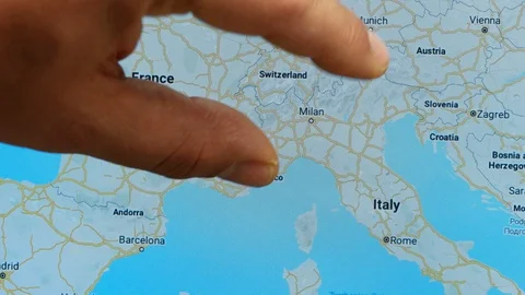 Close up hand gesture on touch screen zoom in Milan city Italy Stock Footage 128461216