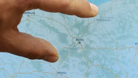 Close up hand gesture on touch screen zoom in Berlin city Germany Stock Footage 128505753