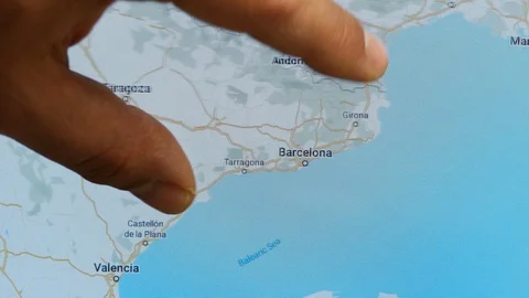 Close up hand gesture on touch screen zoom in barcelona city Spain 動画素材 128506123