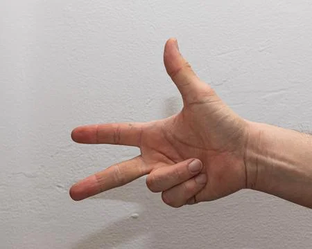 Close-up of a hand gesturing the number three, with three fingers extended,.. Foto stock