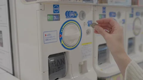 Close up hand gets toy from capsule vending machine Stock Footage 222447591